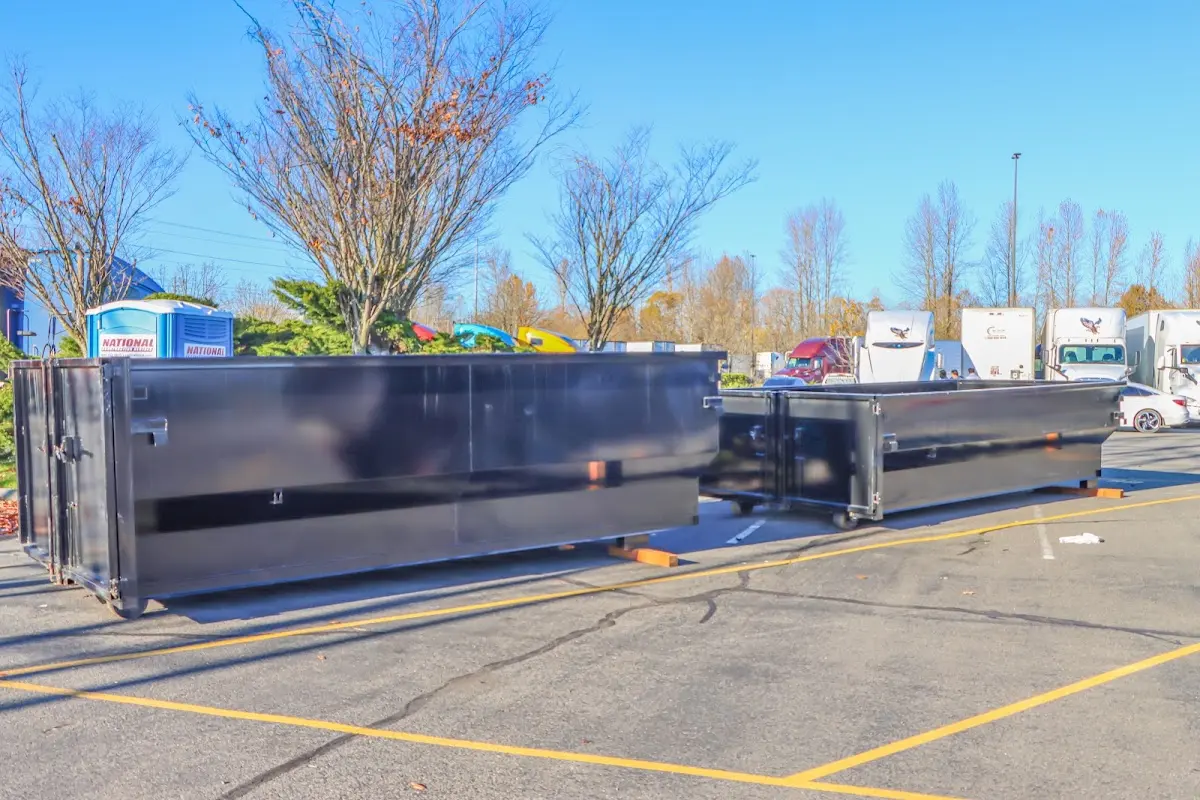 Professional dumpster rental service with roll-off container on residential driveway in Worth
